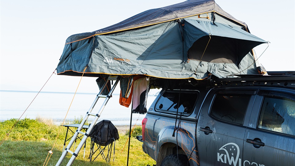 Tuatara Rooftop Tent with towels and clothes hanging outside. Taken at Port Jackson, Coromandel.